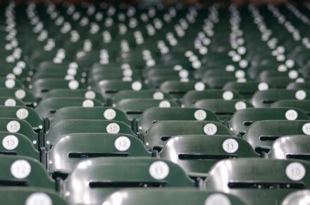 Rows of empty seats in a baseball stadium.