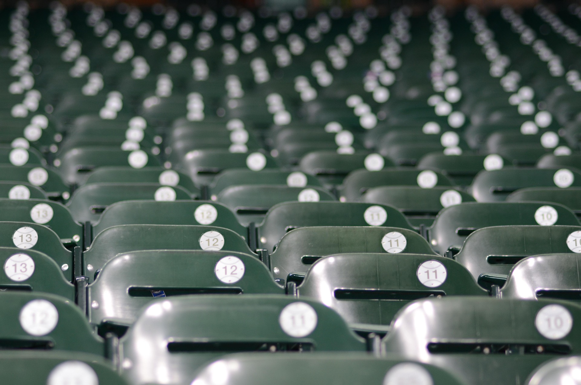 Rows of empty seats in a baseball stadium.
