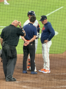 Astros manager Joe Espada talks with players and staff during a mound visit at Daikin Park.