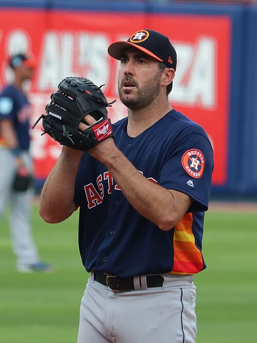 Justin Verlander prepares to throw a pitch while wearing an Astros uniform during spring training
