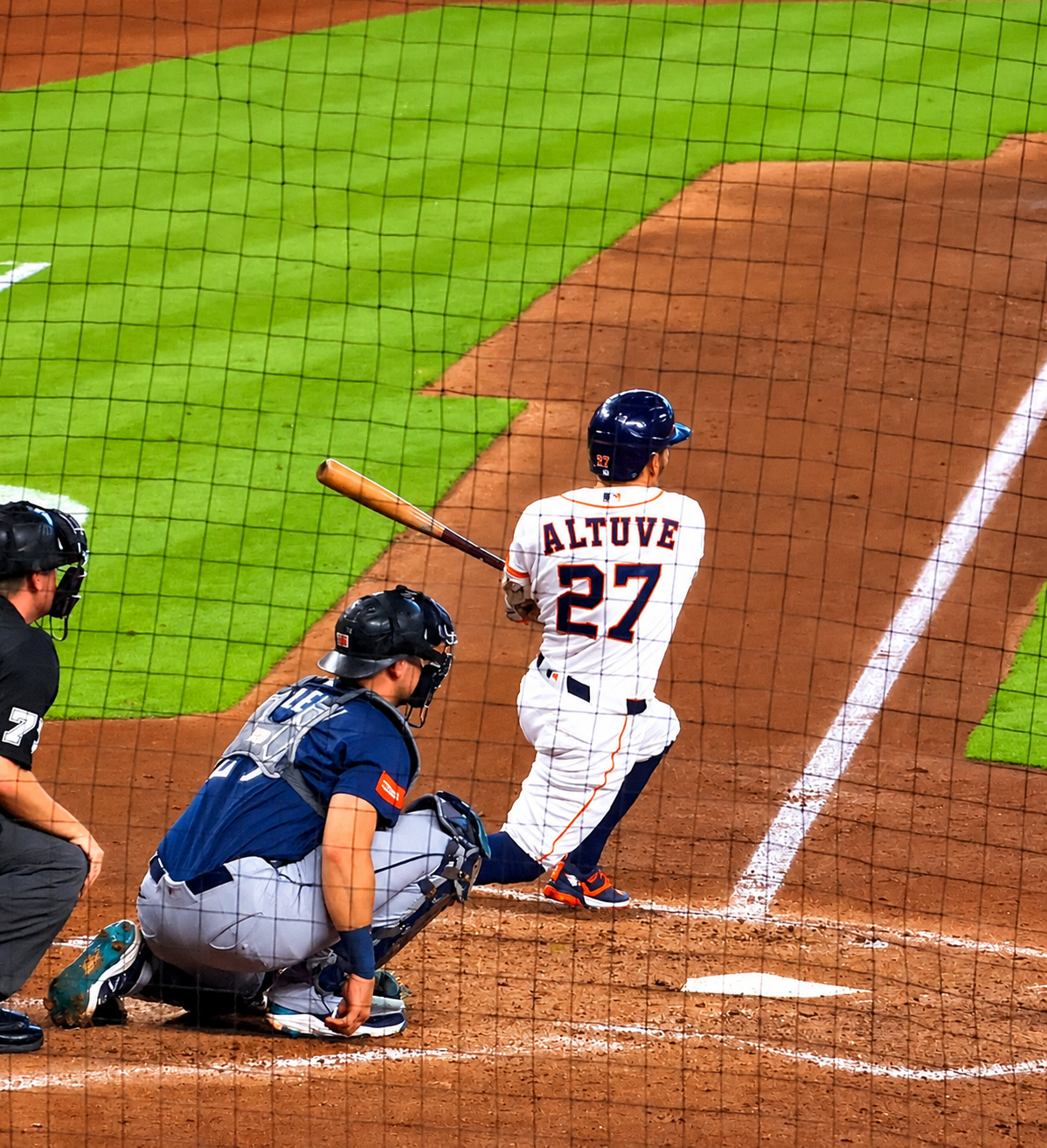 Jose Altuve watches his hit from the batter’s box during an Astros game.