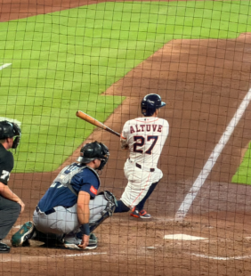 Jose Altuve watches his hit from the batter’s box during an Astros game.