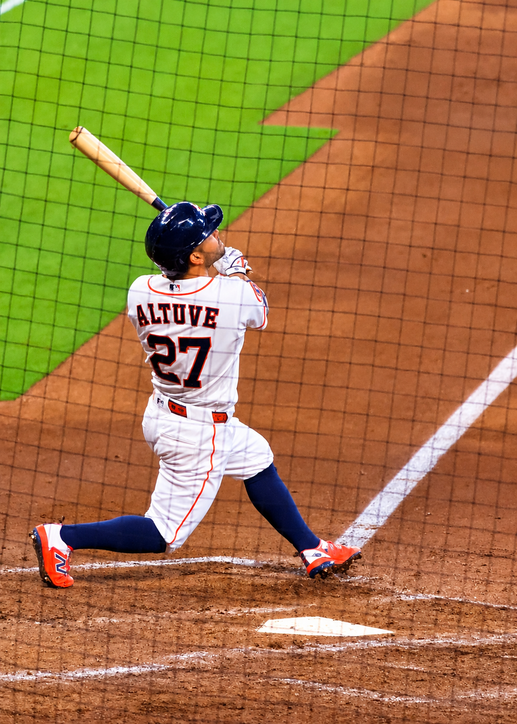 Jose Altuve watches the ball after swinging during an Astros game at Daikin Park.