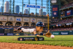 Mauricio Dubón Gold Glove bobblehead makes a diving play on the field at Daikin Park.