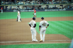 Jason Lane (40), Milwaukee Brewers third-base coach, stands beside a player during a game against the Cincinnati Reds on September 11, 2022.