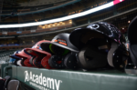 A row of baseball helmets lines the dugout.