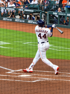 Yordan Alvarez completes his swing at home plate during an Astros game at Daikin Park.